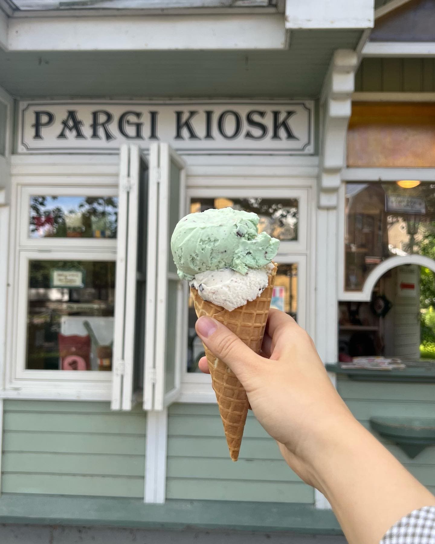 A double scoop of ice cream held up outside the Pargi Kiosk in Tallinn